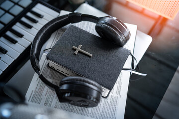 Headphones with Bible in table. listening to christian sermons.