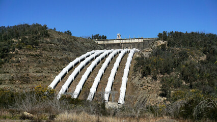 Landscape View of the White Pressure Pipes used to channel Water to Environmentally Friendly Hydro...