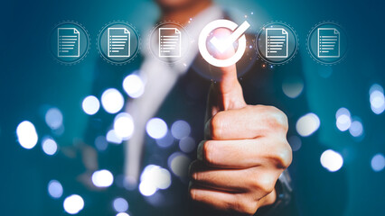 Businessman check and check mark online and thumbs up to approve report document through a virtual screen.
