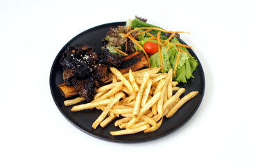Grilled Ribs with French Fries and Vegetables