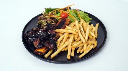 Grilled Ribs with French Fries and Vegetables