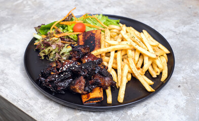 Grilled Ribs with French Fries and Vegetables