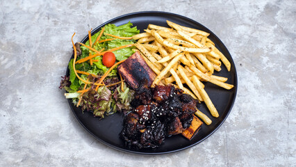 Grilled Ribs with French Fries and Vegetables