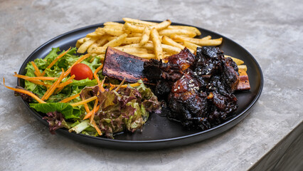 Grilled Ribs with French Fries and Vegetables