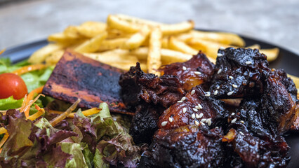Grilled Ribs with French Fries and Vegetables