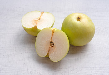 Japanese pear on wooden background. Sweet japanese fruit in autumn.