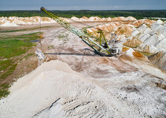 Walking dragline with hoist and bucket works in chalkquarry