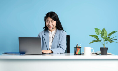 image of an asian consultant using a laptop on a blue background
