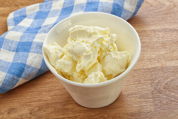 Italian soft mascarpone cheese in the bowl