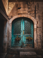Fototapeta na wymiar An old blue wooden door in the streets of the old city