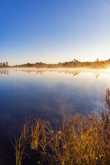 Lakeshore with mist in the autumn