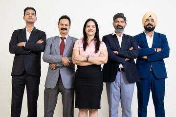 Group of positive indian business people wearing suit standing cross arms looking at camera with smiles isolated on white studio background. Corporate Concept.