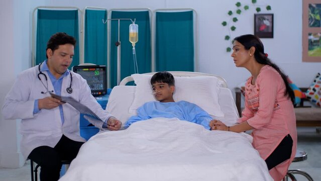 An Indian doctor explaining the X-ray / MRI image to a patient's parent - medical report  radiology  single parent. A concerned Indian lady is sitting by the bedside of her sick son - care and assi...
