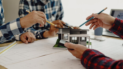 Fototapeta premium 3rd male engineer designing house structure on table in office