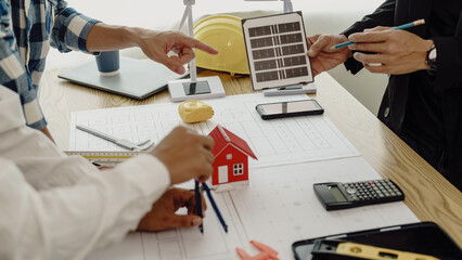 3rd male engineer designing house structure on table in office