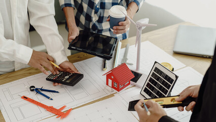 3rd male engineer designing house structure on table in office