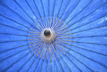 Detail of a blue umbrella in a park in Beijing, China