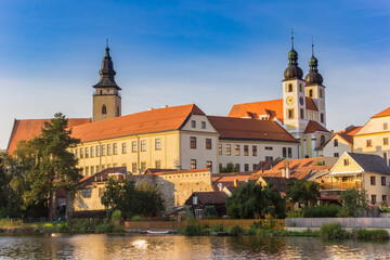 Fototapeta premium Castle and houses at the lake in Telc, Czech Republic