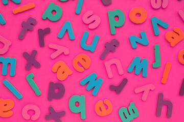 Color alphabet letters on pink background. World Dyslexia Day concept. Solving the educational...