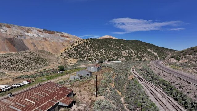 Aerial Ely Nevada copper and gold mine building. Discovered late 1800's. Boom town along historic Pony Express trail. Rural mining community. Ore transported to Japan for smelting. Precious minerals.