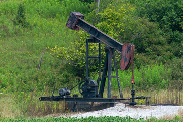 Crude oil machine pumping oil in the fields of Ontario, Canada.