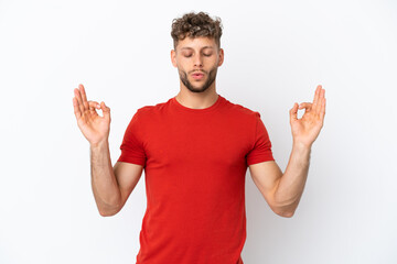Naklejka premium Young caucasian handsome man isolated on white background in zen pose