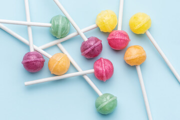 Sweet lollipops and candies on blue background