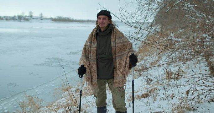 excited happy hicker standing with Nordic walking poles enjoying amazing beautiful landscape on snowy day Slow motion Travel, tourism, Sport, guy leads active lifestyle