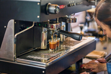 Coffee machine working for espresso shot by two barista in coffee cafe.