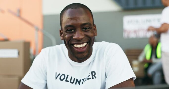 Happy black man, volunteer and community service with smile in NGO, charity or teamwork. Portrait of African male person, face or volunteering worker in happiness for distribution and contribution