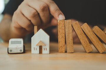 Hands protect domino. Businessman hands stop dominoes falling effect from continuous toppled to...