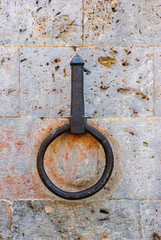 Fototapeta premium Ancient Iron ring to tie horses on stone wall, Siena Tuscany Italy