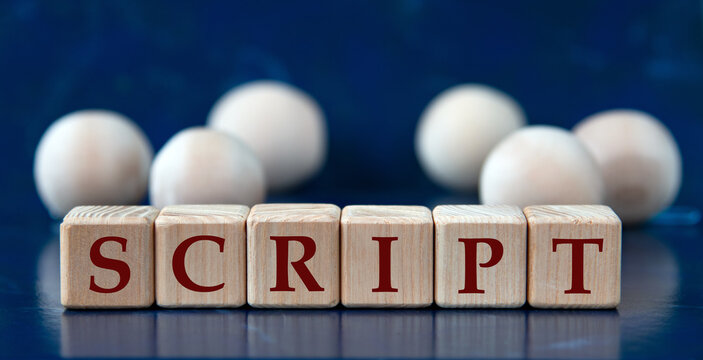 SCRIPT - word on wooden cubes on a blue background with wooden balls