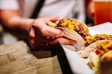 man hand holding taco traditional mexican food