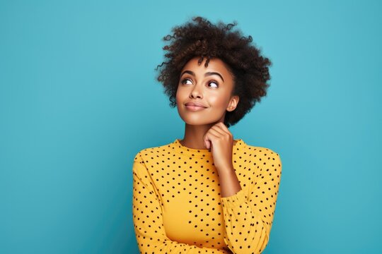 Surprise African Woman Wear Dotted Dress Thinking About Question On Bright Blue Color Background . Сoncept African Womens Fashion, Thinking Beyond The Norm, Surprises Around Every Corner