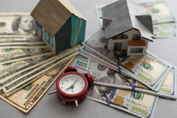 building, mortgage, investment, real estate and property concept - close up of home or house model and money.