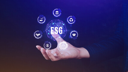 ESG icon concept in the hand for environmental, social and governance in sustainable and ethical business on the Network connection, businessman pressing button on screen.