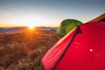 Colorful hiking tents at the sunset