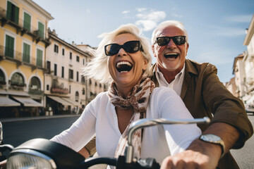 Happy senior couple having fun! Riding motor bike scooter across the town and waving! Retirement adventure life.