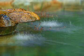 pond with stone mushroom, frozen water