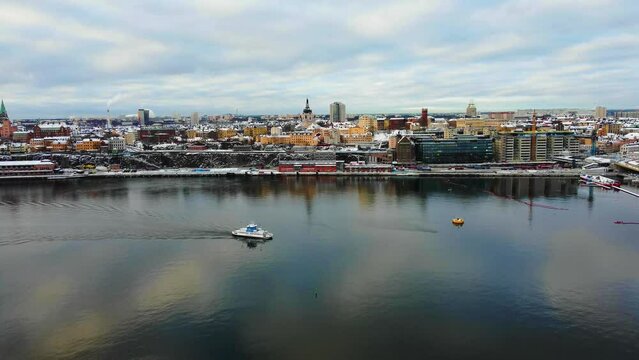 Beautiful winter aerial view of Stockholm city, Sweden. Old town, seascape, snow and colorful buildings. 4K resolution, 30 fps.