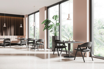 Beige cafeteria interior with chairs and table, eating space with window