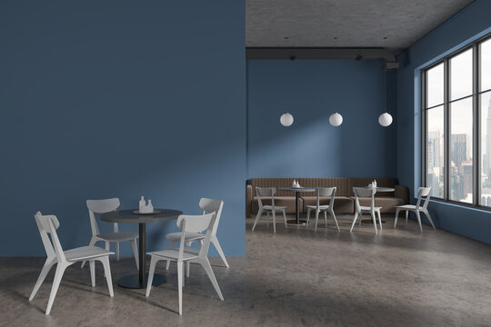 Blue cafeteria interior with seats and table with sofa near window, mockup wall