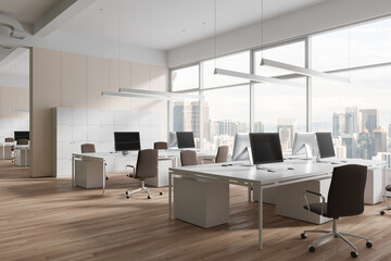 Cozy coworking interior with pc computers and chairs in row, window