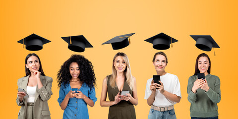 Young women students in row using phone, graduation and online education