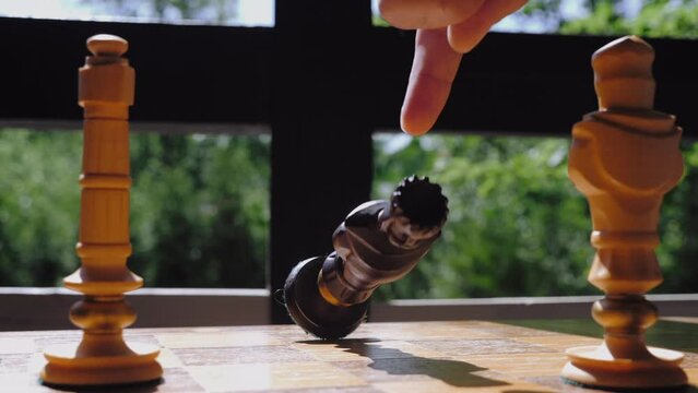 The concept of checkmate in a chess game. The fall of the king.