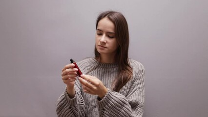 teenager girl looks at a disposable cigarette, stop vape smoking, tobacco addiction of minors, choice of young people, nicotine refusal