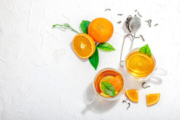 Orange tea in glass cups with ripe fruits. Refreshment seasonal drink, conceptual background