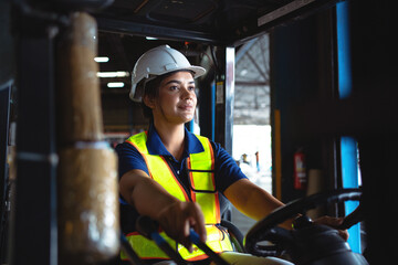 Professional workers in the warehouse. Female worker driving a forklift in a warehouse worker working in warehouse - obrazy, fototapety, plakaty