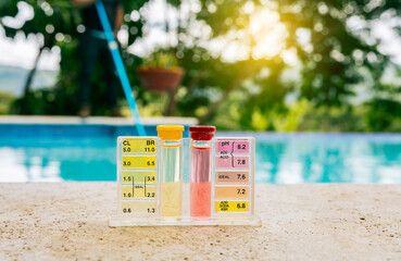 Tester kit to measure chlorine and ph in swimming pools. Pool water PH tester kit on the edge of...